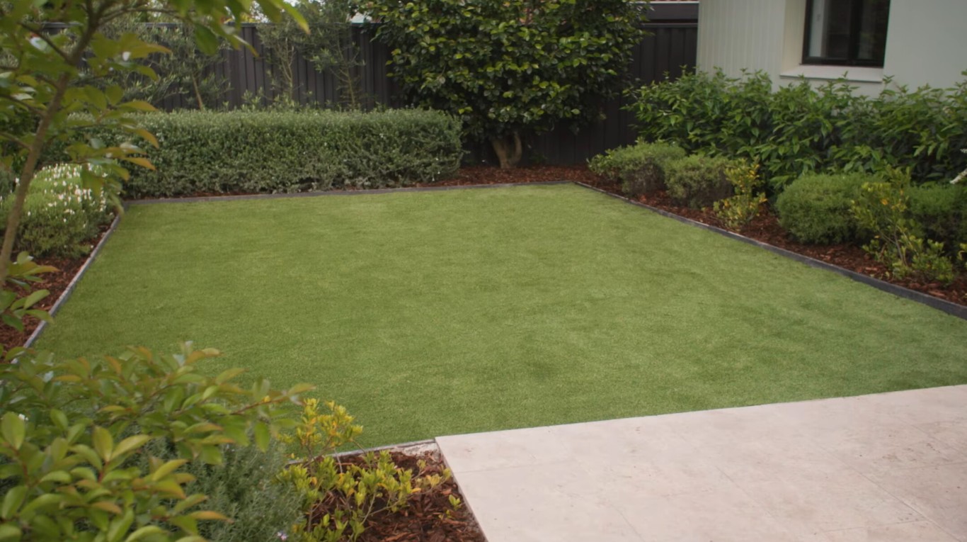 Pristine artificial grass lawn installation in residential backyard in St. Charles, MO